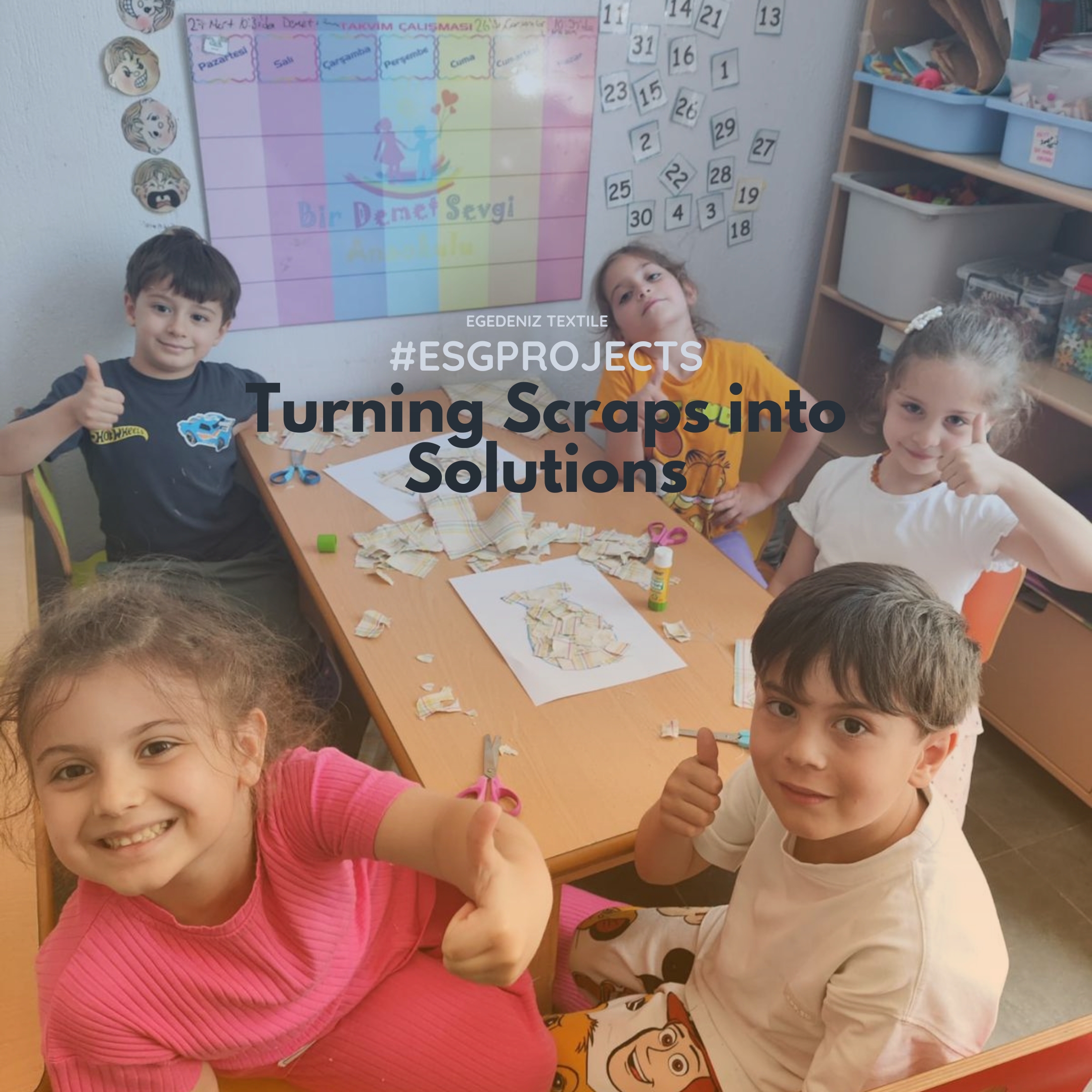 Five happy young children at Bir Demet Sevgi Anaokulu in Urla, Izmir, giving thumbs up while working on an art project with Egedeniz Textile fabric scraps. The image shows the children engaged in fabric scraps education to learn about reuse.